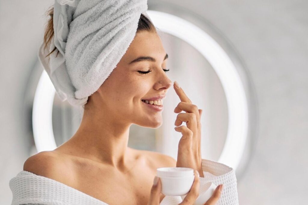 donna che mette crema sul viso
